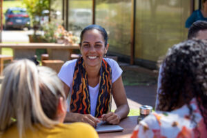 Image of woman speaking to community members.